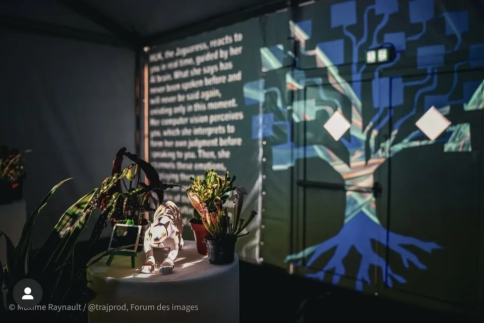 A projected tree with blue roots beside a wall of text, and a white jaguar figure among plants.